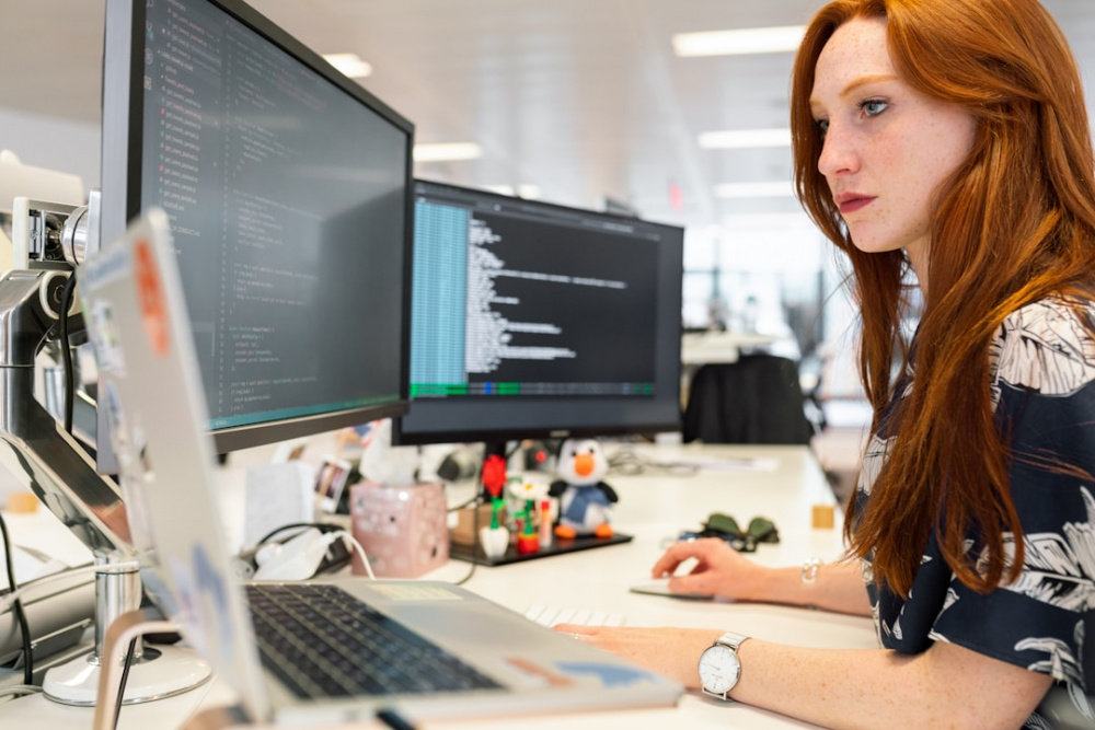 A woman in an office researching PSA software in an office